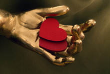 Two Red Hearts In A Gold Hand