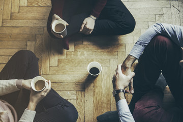 Socializng concept - friends taking a coffee and talking, hipster mood