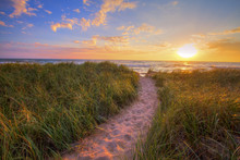 Path To A Summer Sunset Beach. Winding Trail Through Dune Grass Leads To A Sunset Beach On The Coast Of The Inland Sea Of Lake Michigan. Hoffmaster State Park. Muskegon, Michigan.