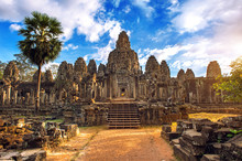 Ancient Stone Faces At Sunset Of Bayon Temple, Angkor Wat, Siam