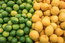 Counter With Fresh Citrus Fruits From A Market,  Lime And Lemons, Very Colorful And Vibrant.