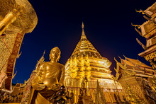 Gold Pagoda And Gold Buddha Statue With Blue Sky At Wat Phra Tha