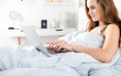 © leszekglasner - Young girl using laptop in bed at home