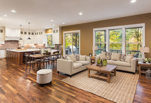 Beautiful Living Room Interior With Hardwood Floors And View Of Kitchen In New Luxury Home