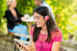 © jackfrog - A  young woman listening to music on a smartphone with a headset