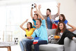 © Africa Studio - Soccer fans with France flag emotionally watching game in the room