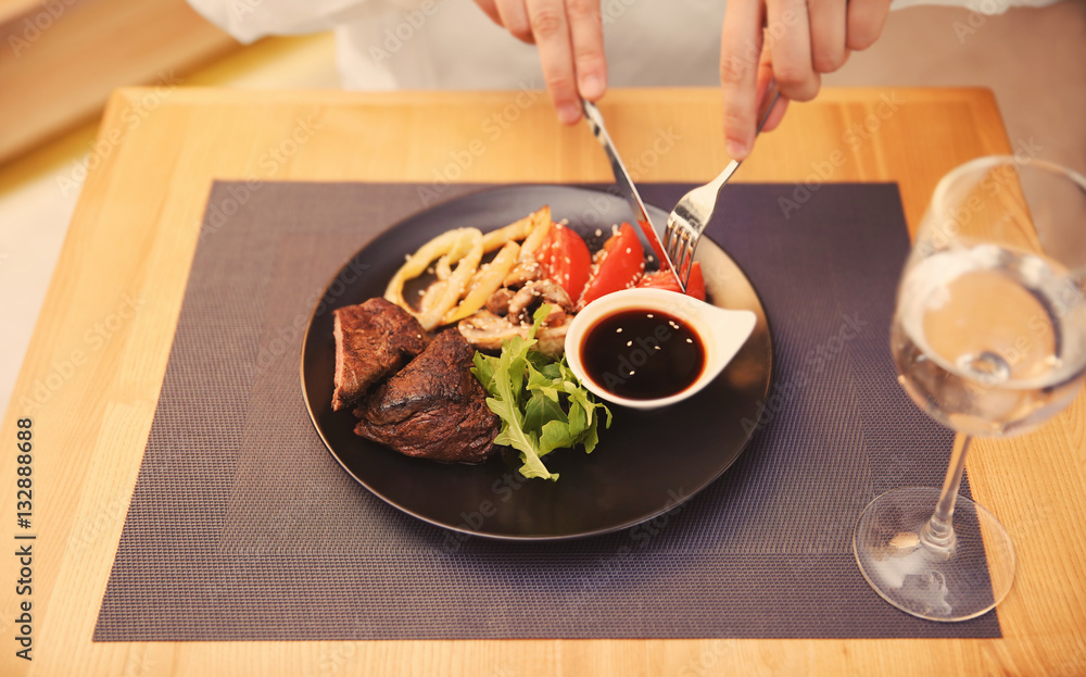 Client eating tasty dish in restaurant, close up