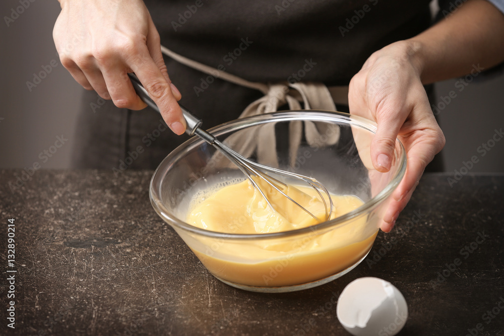 Young woman cooking in kitchen, closeup