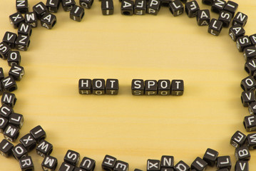 The word Hot spot on wood background