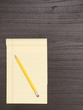 © danadestinations - Wood Desk, Yellow Notepad, Pencil
