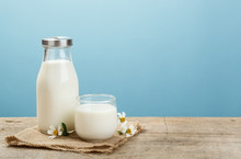A Bottle Of Rustic Milk And Glass Of Milk On A Wooden Table On A