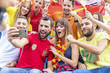 © Lumi Images - Soccer fans in stadium taking a selfie