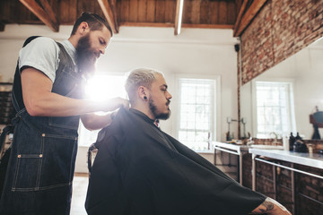 Wall Mural - Handsome young man getting haircut