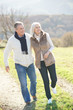 © goodluz - Senior couple walking in countryside on winter day