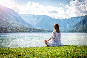 Woman meditating at the lake