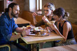 © Lumi Images - Group of friends eating snacks in coffee shop