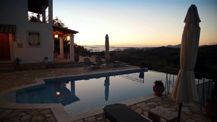 Wall Mural - Camera tracking during sunrise at a beautiful Mediterranean villa with swimming pool