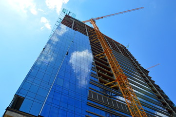 Construction of a skyscraper monolith and brick construction elements from a number of tower crane.