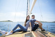 © Lumi Images - Young couple sits back to back on sail ship