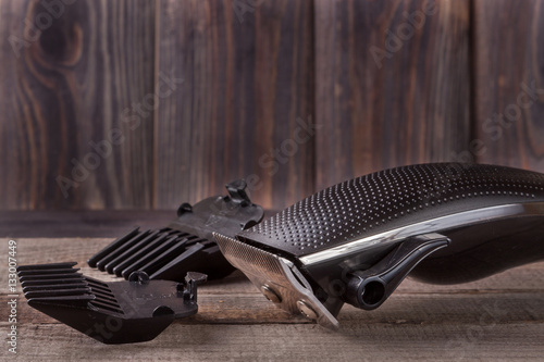 Fotografie, Obraz hair trimmer on an old wooden background closeup