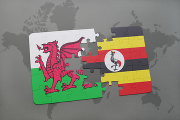 Wall Mural - puzzle with the national flag of wales and uganda on a world map