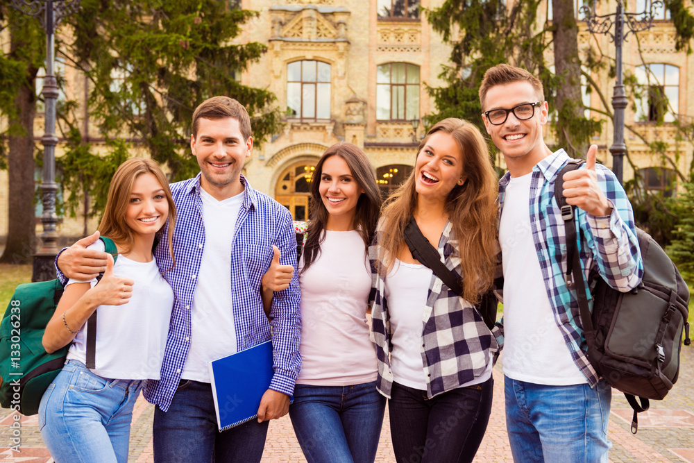 Portrait of group of happy students showing thumbs up Stock Photo ...