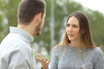 Couple talking seriously outdoors