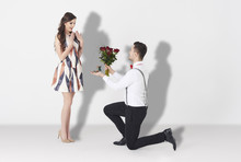 Young Man Surprising Woman With Engagement .