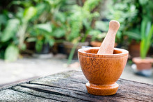 Asia Antique Style Wooden Mortar With Wooden Pestle In Outdoor Garden.
