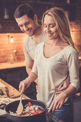 Wall Mural - Beautiful couple cooking