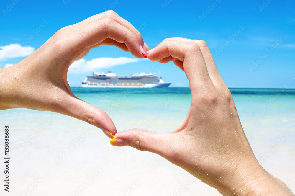 Cruise vacation concept. Cruise ship in the sea near the tropical island inside hands making heart shape. Tropical Resort. Vacation concept. Summer holidays. Tourism.  - obrazy, fototapety, plakaty 