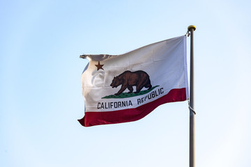 Flag of California on the blue sky background