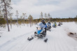 man driving snowmobile in Finnish Lapland