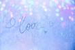 Love - a beautiful inscription on the frosty glass