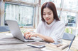 © kudosstudio - young happy casual asian woman using technology on her laptop co