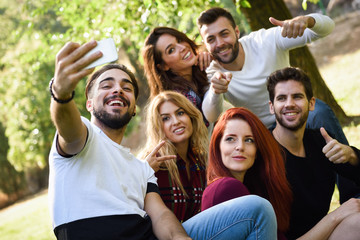 Wall Mural - Group of friends taking selfie in urban background