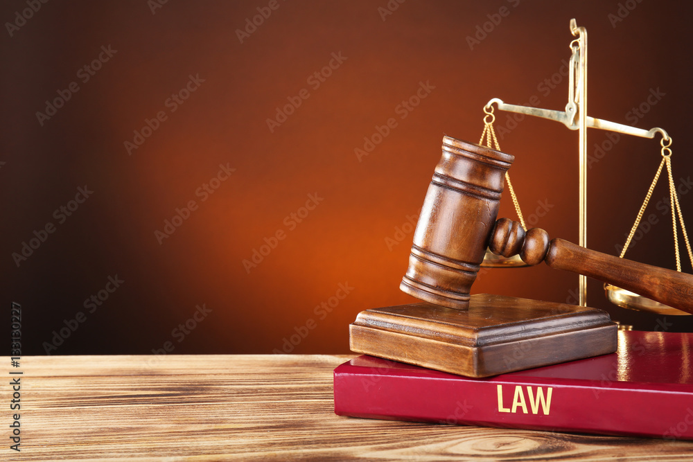 Judge gavel, scales and book on wooden table