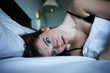 © GAM Studios - Portrait of pensive and sad woman in bed with green eyes