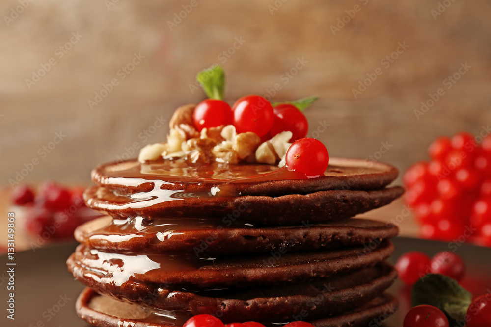 Tasty chocolate pancakes with  viburnum and nuts, closeup
