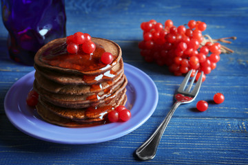 Wall Mural - Delicious chocolate pancakes with  viburnum on blue wooden table