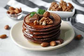 Sticker - Delicious chocolate pancakes decorated with nuts and sweet syrup on plate