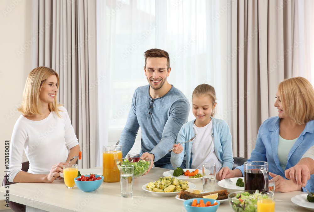 Happy family having lunch in kitchen