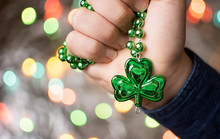 Male Hand Holding Clover Green Necklace