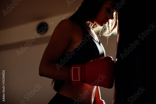 sexy fighter girl in gym with boxing bag Tablou Canvas