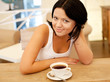 © Raisa Kanareva - young woman sitting in a cafe drinking coffee