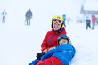 © cromary - Two happy school boys, twin brothers in colorful snowsuits, having fun skiing in alpine mountains during snowy winter vacation