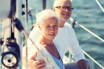 Poster - senior couple hugging on sail boat or yacht in sea