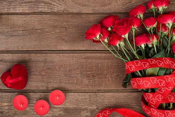 Red roses on wooden background.