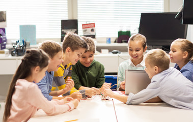 Wall Mural - happy children with laptop at robotics school