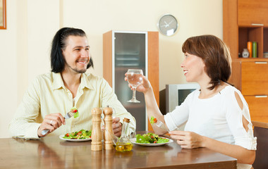 Wall Mural - couple having dinner with vegetables in sweet home